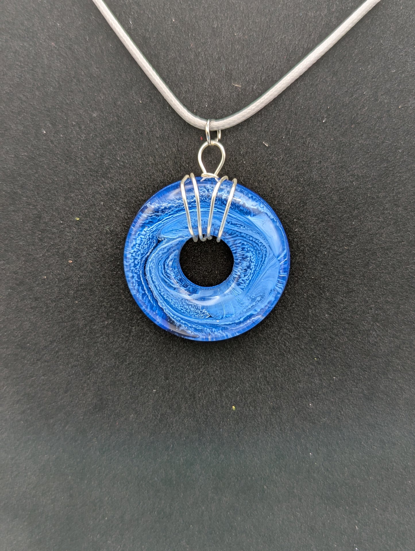 Wire Wrapped Donut Resin Pendant Necklace - Petri Effect with shades of blue swirls. Resin Necklace on a waxed cotton cord.