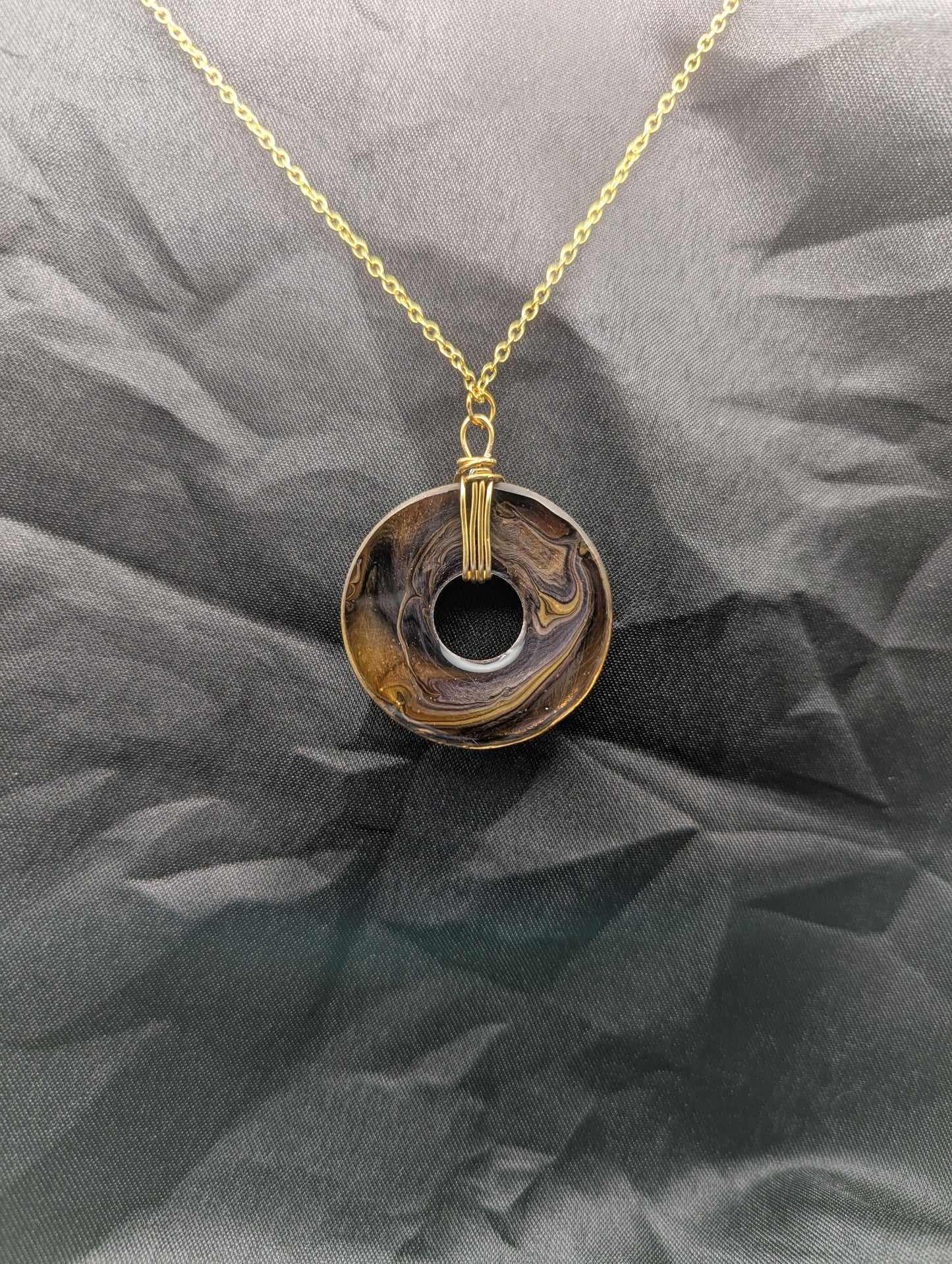 Back view of Wire Wrapped Donut Resin Pendant Necklace - Petri Effect with shades of yellow & brown swirls. Resin Necklace on a waxed cotton cord.