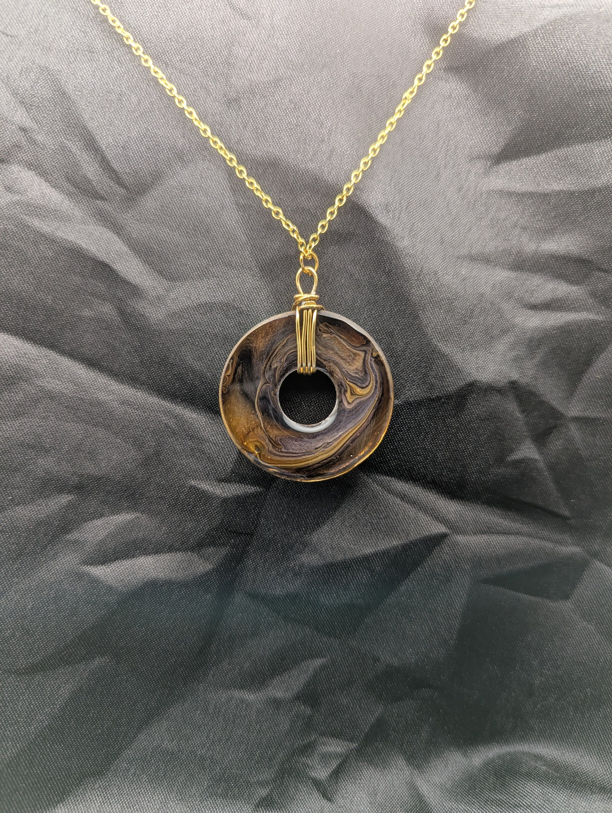 Back view of Wire Wrapped Donut Resin Pendant Necklace - Petri Effect with shades of yellow & brown swirls. Resin Necklace on a waxed cotton cord.