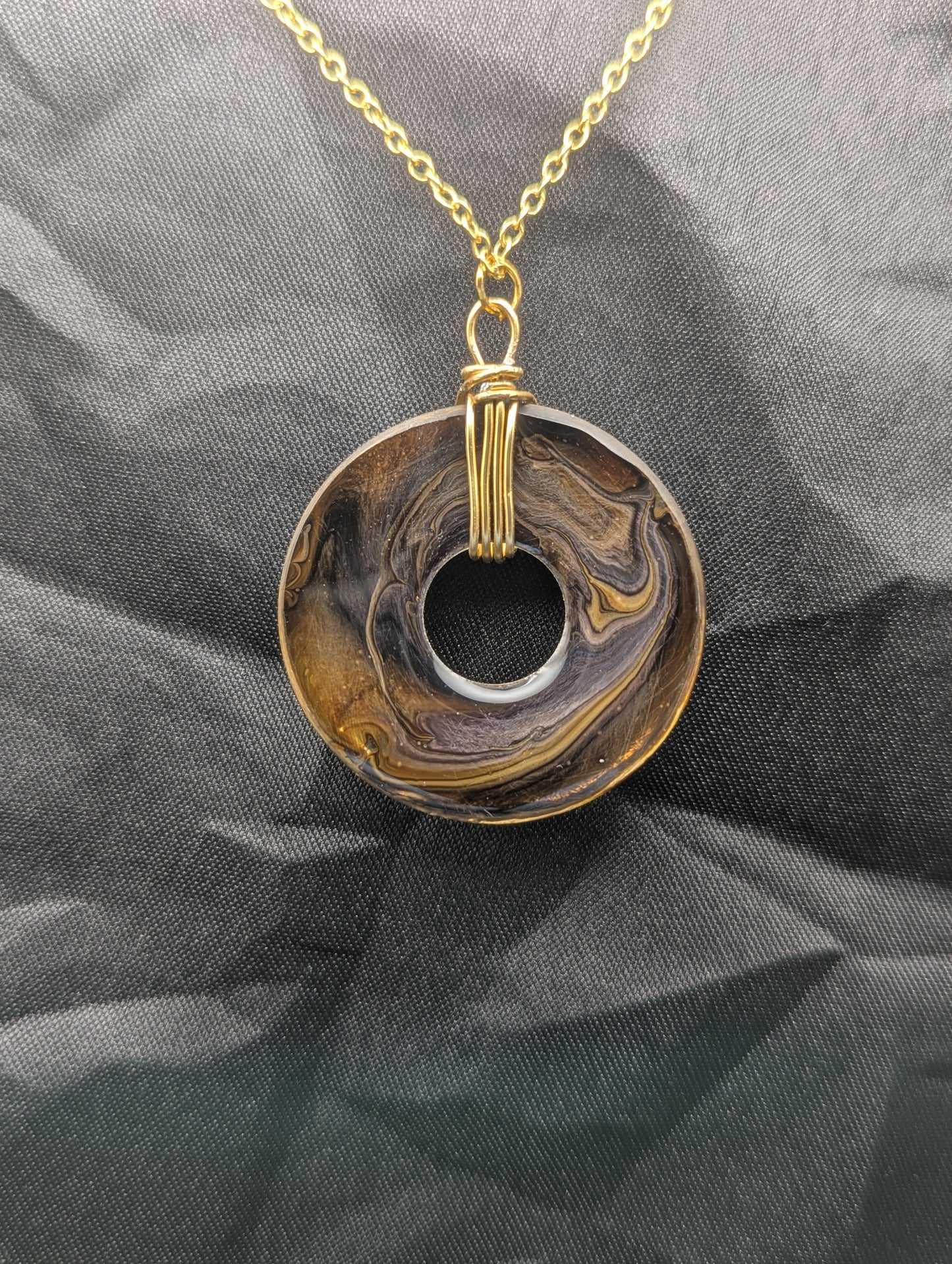 Back view of Wire Wrapped Donut Resin Pendant Necklace - Petri Effect with shades of yellow & brown swirls. Resin Necklace on a waxed cotton cord.