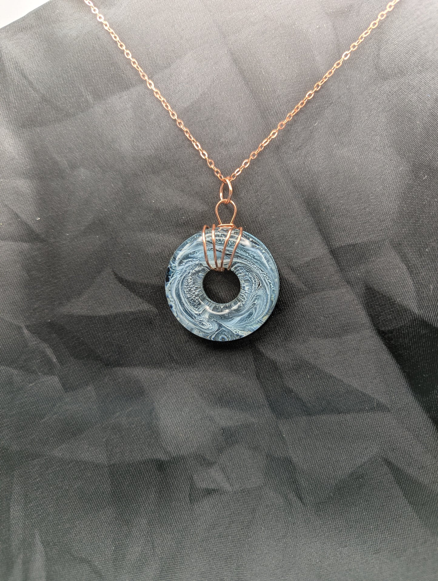 Wire Wrapped Donut Resin Pendant Necklace - Petri Effect with shades of blue & black swirls. Resin Necklace on copper plated stainless steel chain.