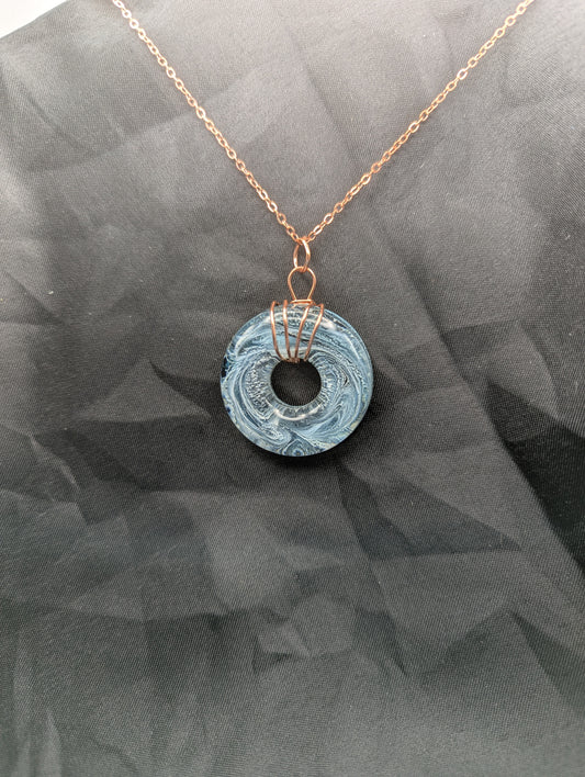 Wire Wrapped Donut Resin Pendant Necklace - Petri Effect with shades of blue & black swirls. Resin Necklace on copper plated stainless steel chain.