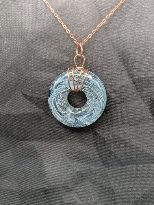 Wire Wrapped Donut Resin Pendant Necklace - Petri Effect with shades of blue & black swirls. Resin Necklace on copper plated stainless steel chain.