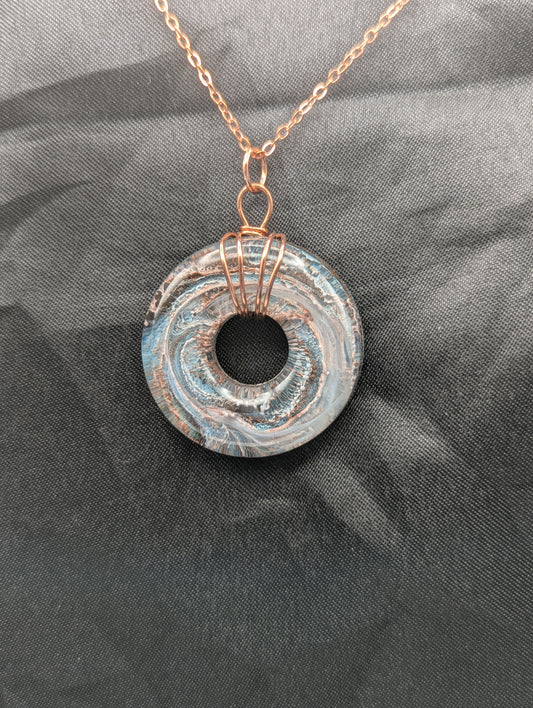 Wire Wrapped Donut Resin Pendant Necklace - Petri Effect with shades of blue & metallic bronze swirls. Resin Necklace on a rose gold colored stainless steel metal chain