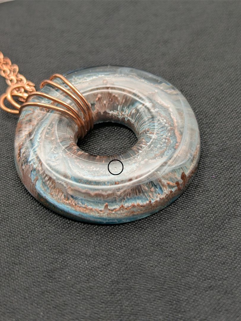 Wire Wrapped Donut Resin Pendant Necklace - Petri Effect with shades of blue & metallic bronze swirls. Resin Necklace on a rose gold colored stainless steel metal chain