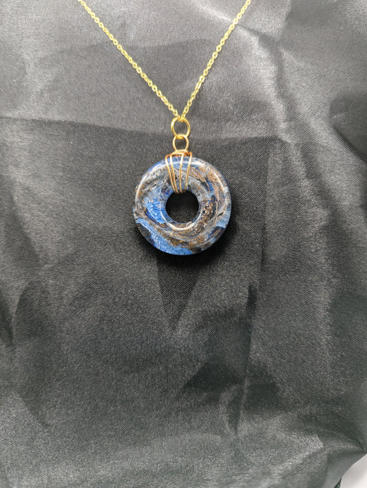 Wire Wrapped Donut Resin Pendant Necklace - Petri Effect with shades of blue & bronze swirls. Resin Necklace on a gold plated metal chain.