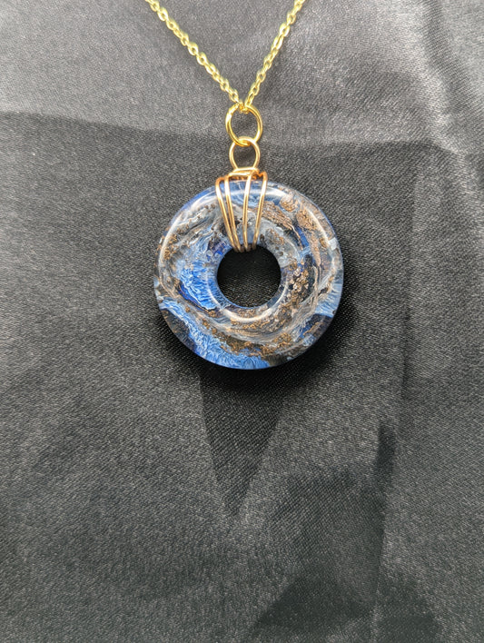 Wire Wrapped Donut Resin Pendant Necklace - Petri Effect with shades of blue & bronze swirls. Resin Necklace on a gold plated metal chain.