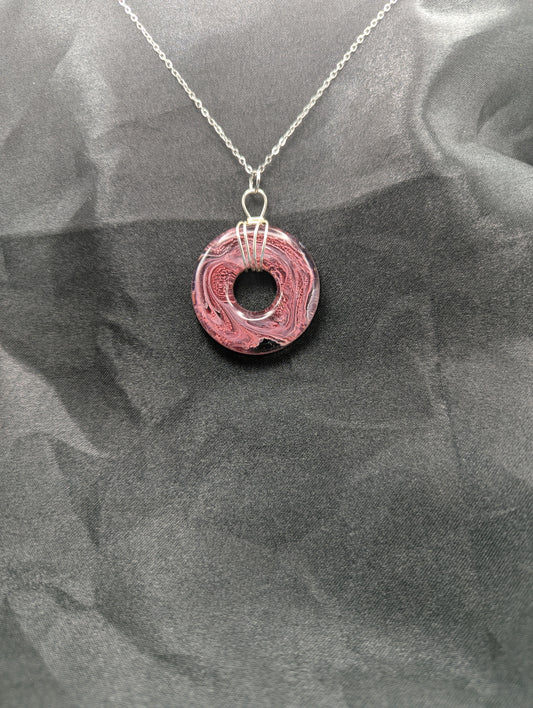Wire Wrapped Donut Resin Pendant Necklace - Petri Effect with shades of red, pink, & black swirls. Resin Necklace on a stainless steel chain.