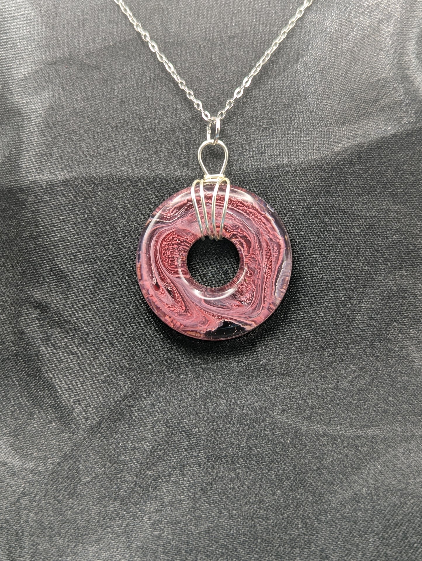 Wire Wrapped Donut Resin Pendant Necklace - Petri Effect with shades of red, pink, & black swirls. Resin Necklace on a stainless steel chain.