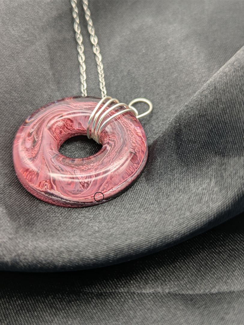 Wire Wrapped Donut Resin Pendant Necklace - Petri Effect with shades of red, pink, & black swirls. Resin Necklace on a stainless steel chain.