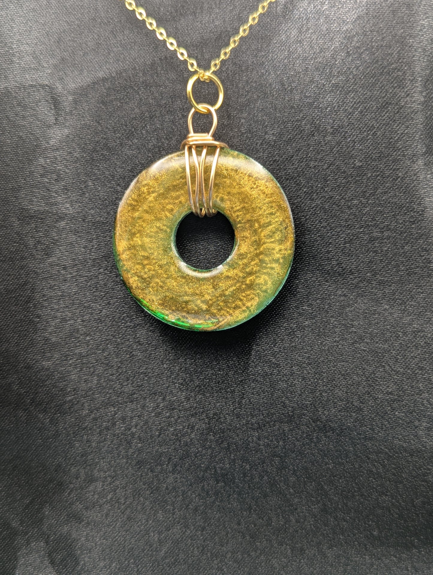 Wire Wrapped Donut Resin Pendant Necklace - Petri Effect with shades of green & brass swirls. Resin Necklace on a gold plated metal chain.