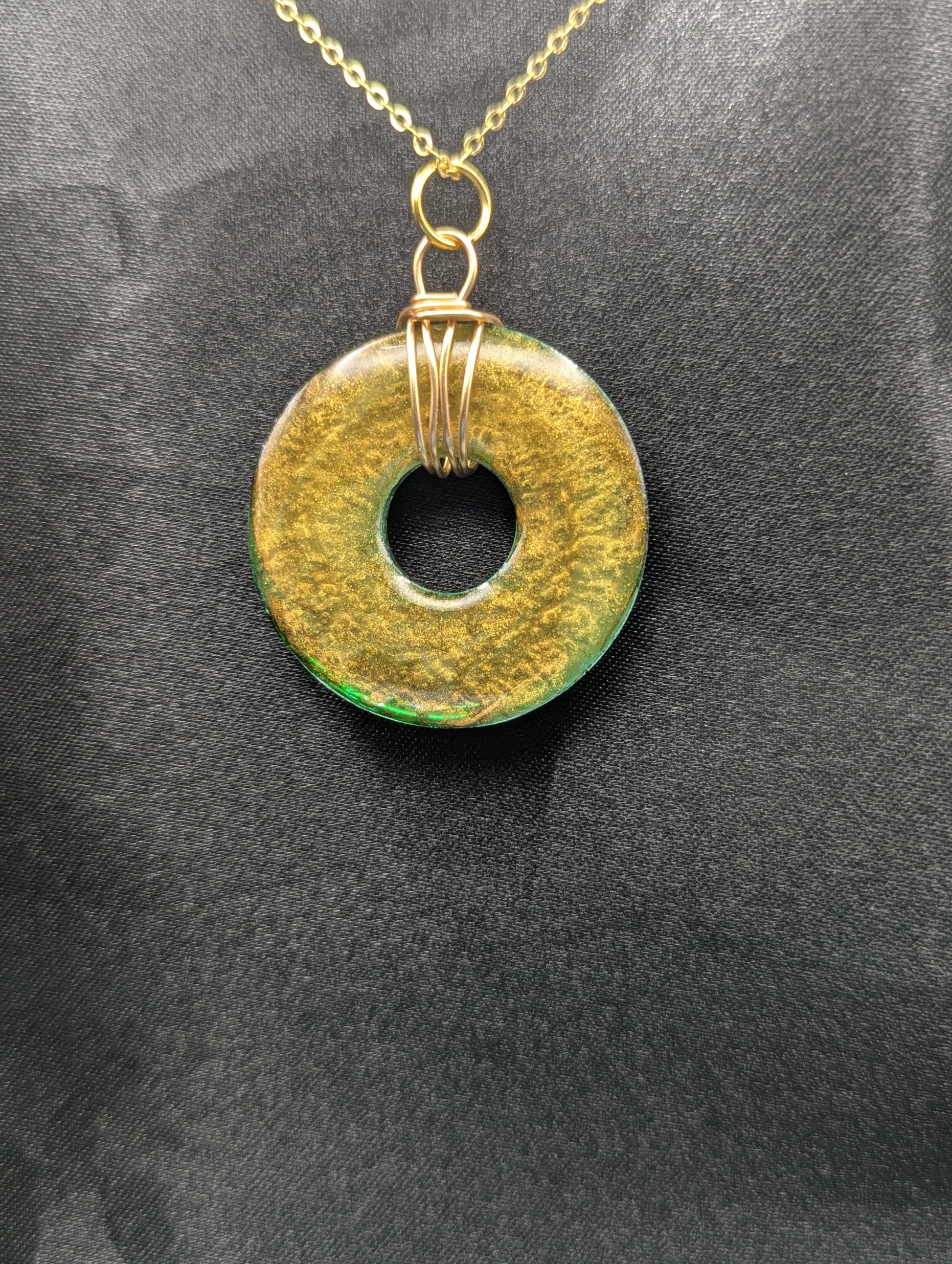 Wire Wrapped Donut Resin Pendant Necklace - Petri Effect with shades of green & brass swirls. Resin Necklace on a gold plated metal chain.