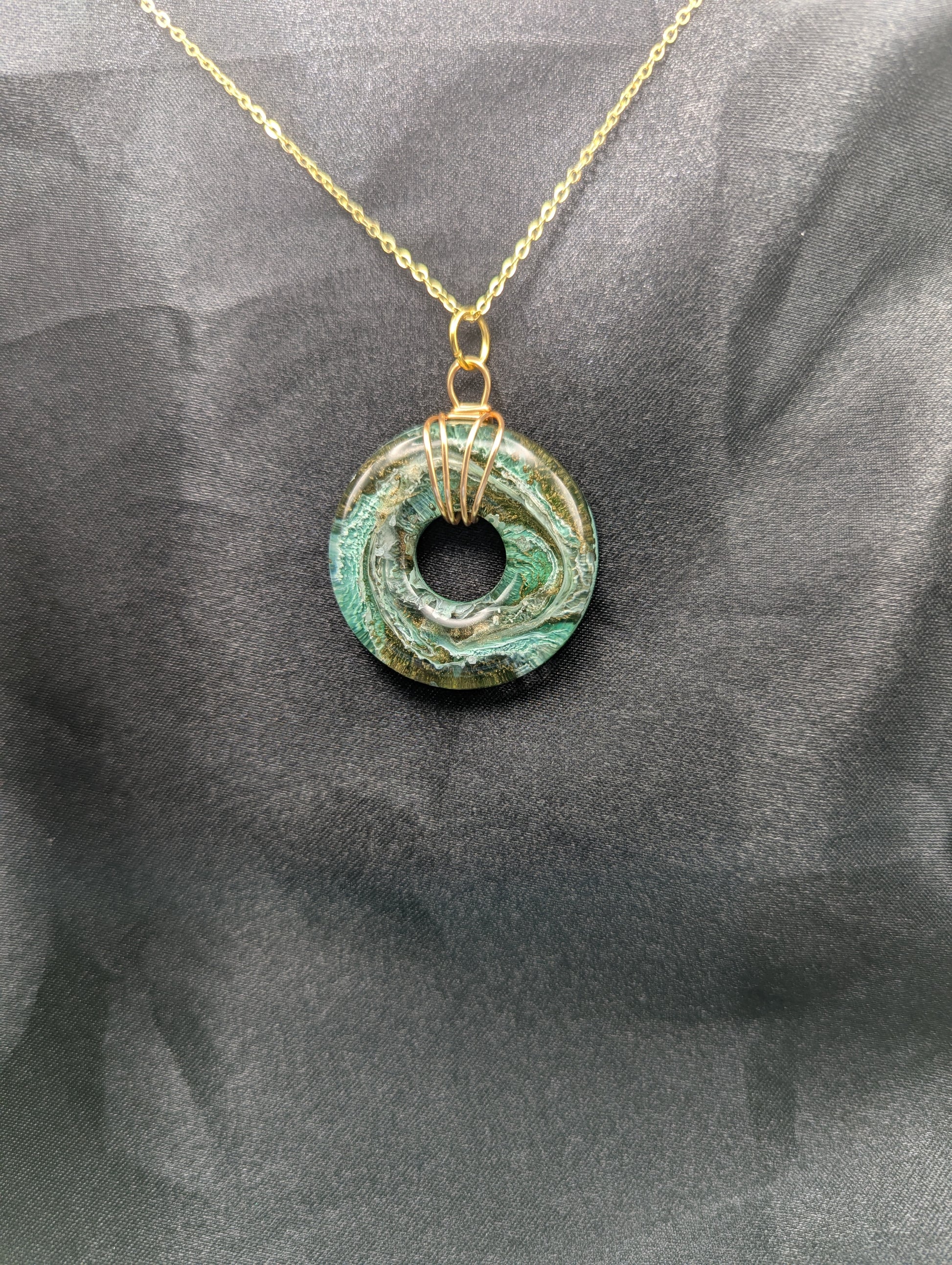 Wire Wrapped Donut Resin Pendant Necklace - Petri Effect with shades of green & brass swirls. Resin Necklace on a gold plated metal chain.