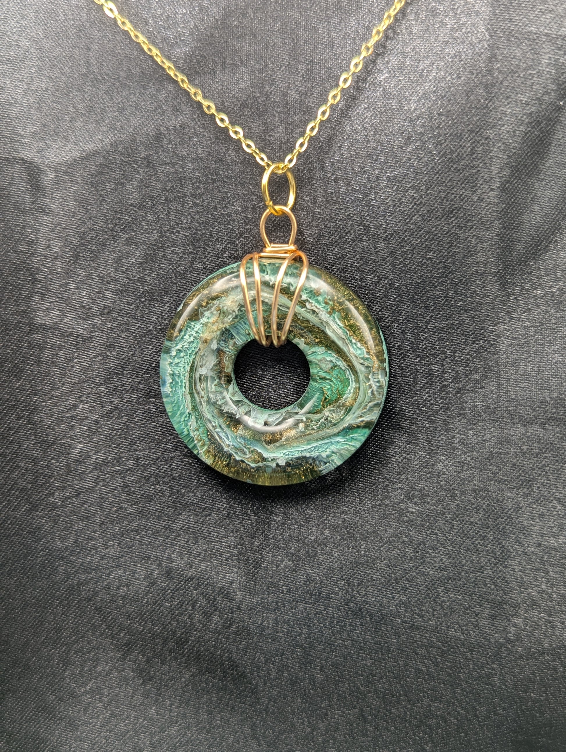 Wire Wrapped Donut Resin Pendant Necklace - Petri Effect with shades of green & brass swirls. Resin Necklace on a gold plated metal chain.