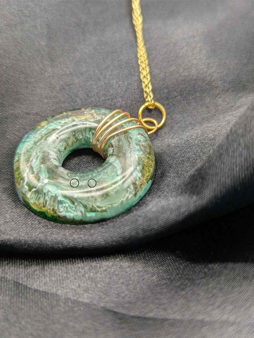 Wire Wrapped Donut Resin Pendant Necklace - Petri Effect with shades of green & brass swirls. Resin Necklace on a gold plated metal chain.