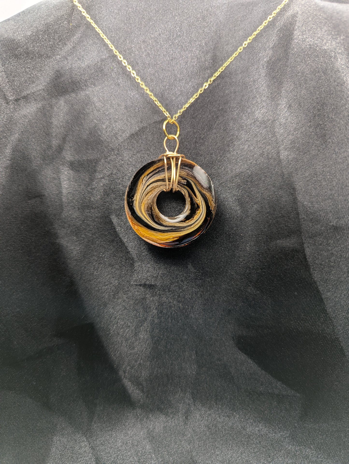 Back view of Wire Wrapped Donut Resin Pendant Necklace - Petri Effect with shades of brown & yellow swirls. Resin Necklace on a gold plated metal chain.