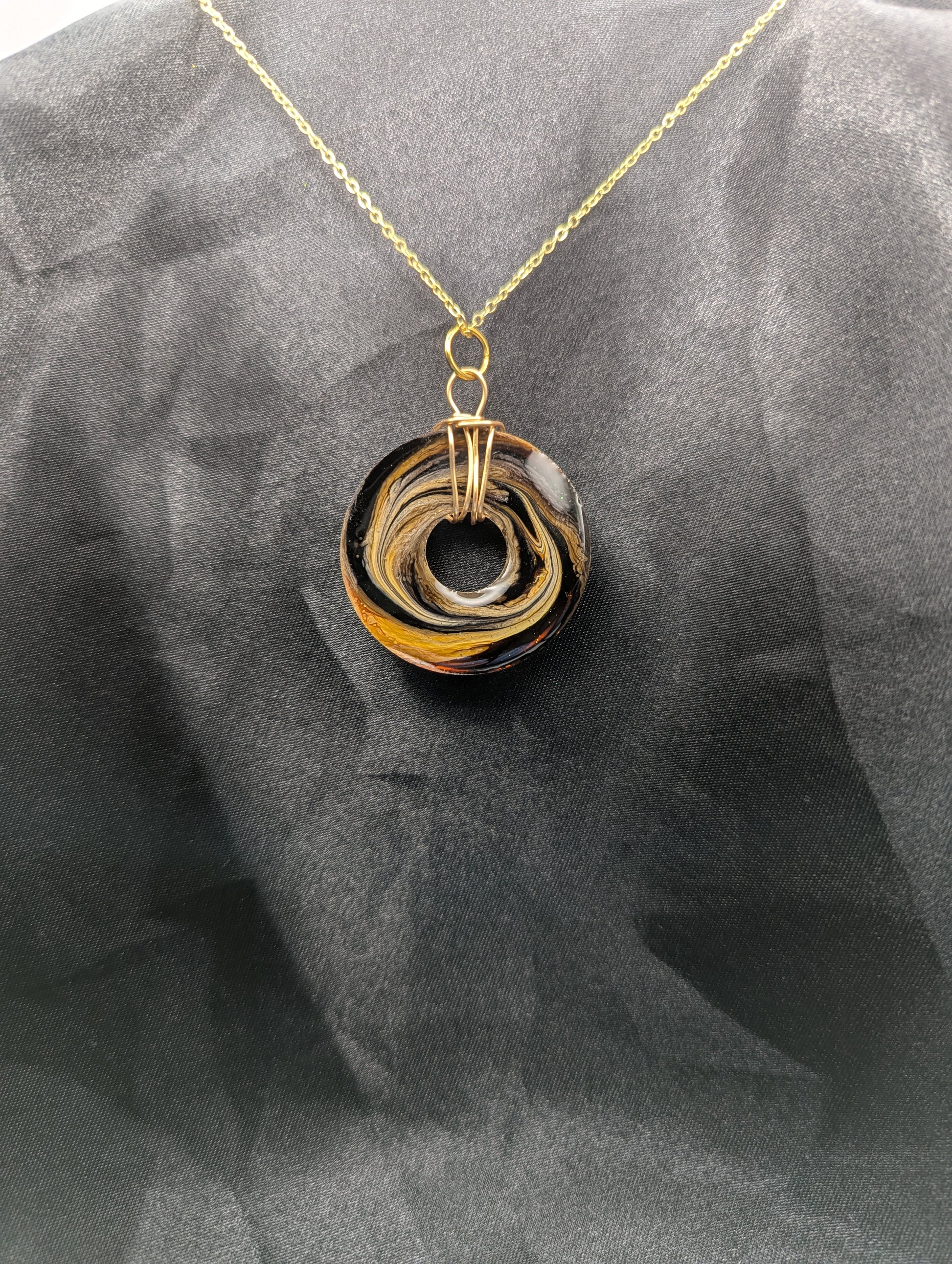 Back view of Wire Wrapped Donut Resin Pendant Necklace - Petri Effect with shades of brown & yellow swirls. Resin Necklace on a gold plated metal chain.