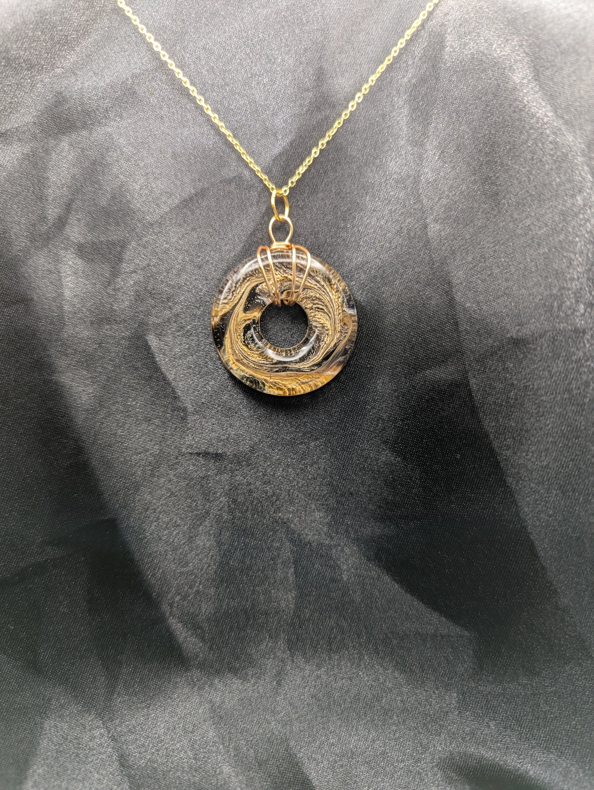 Wire Wrapped Donut Resin Pendant Necklace - Petri Effect with shades of brown & yellow swirls. Resin Necklace on a gold plated metal chain.