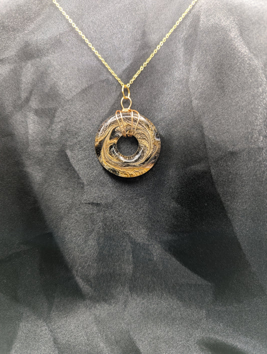 Wire Wrapped Donut Resin Pendant Necklace - Petri Effect with shades of brown & yellow swirls. Resin Necklace on a gold plated metal chain.