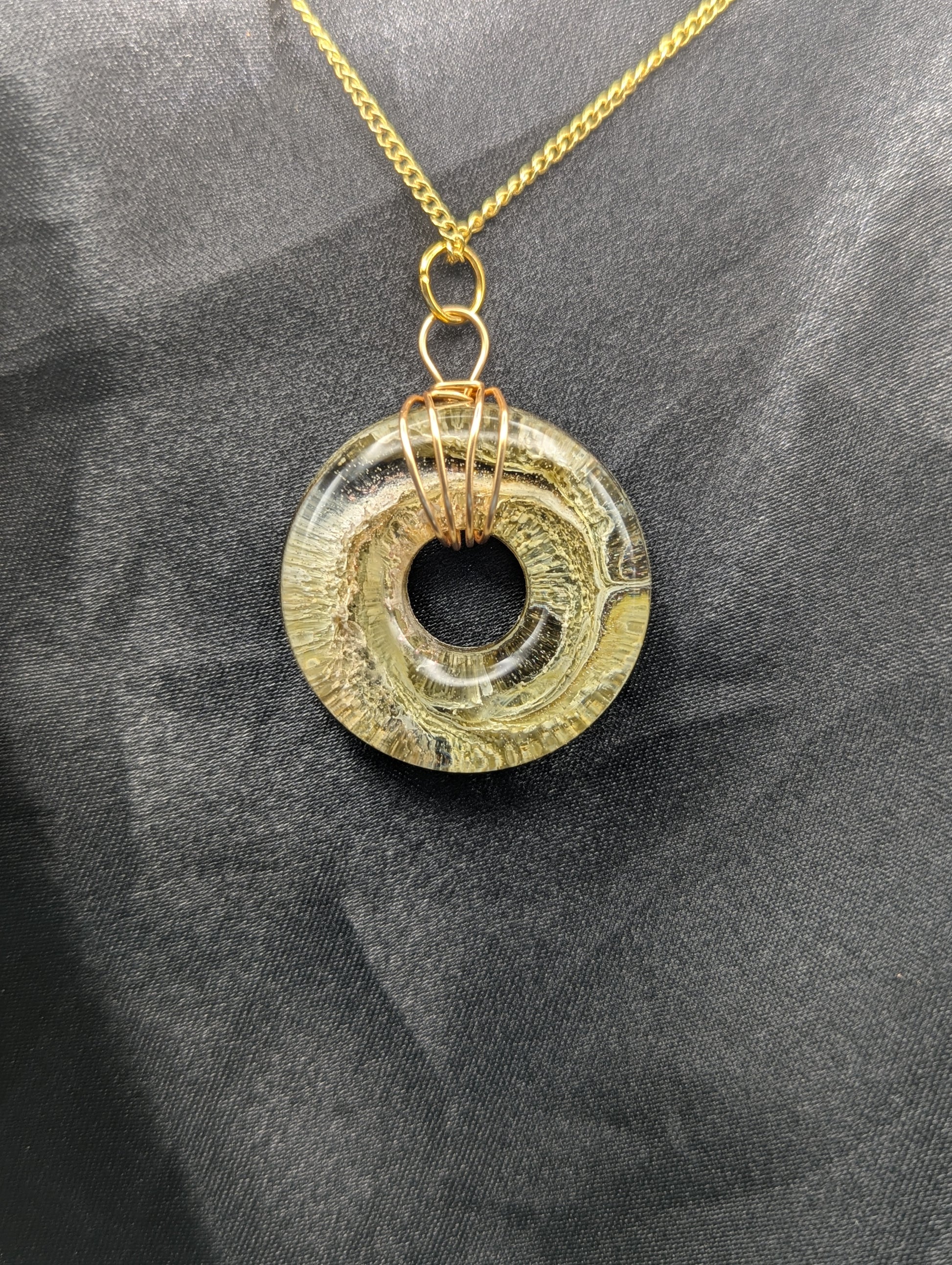 Wire Wrapped Donut Resin Pendant Necklace - Petri Effect with shades of light yellow & light green swirls. Resin Necklace on a gold plated metal chain.