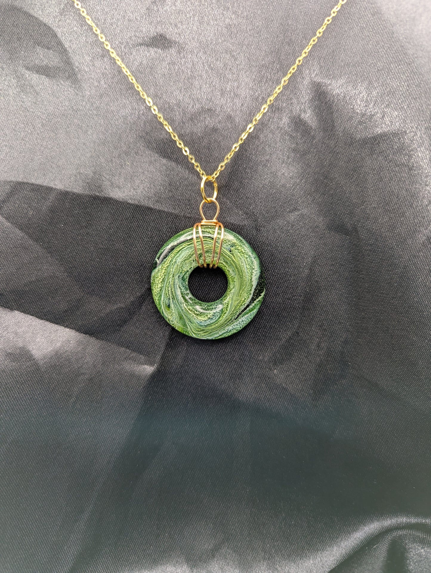 Wire Wrapped Donut Resin Pendant Necklace - Petri Effect with shades of green swirls. Resin Necklace on a gold plated metal chain.