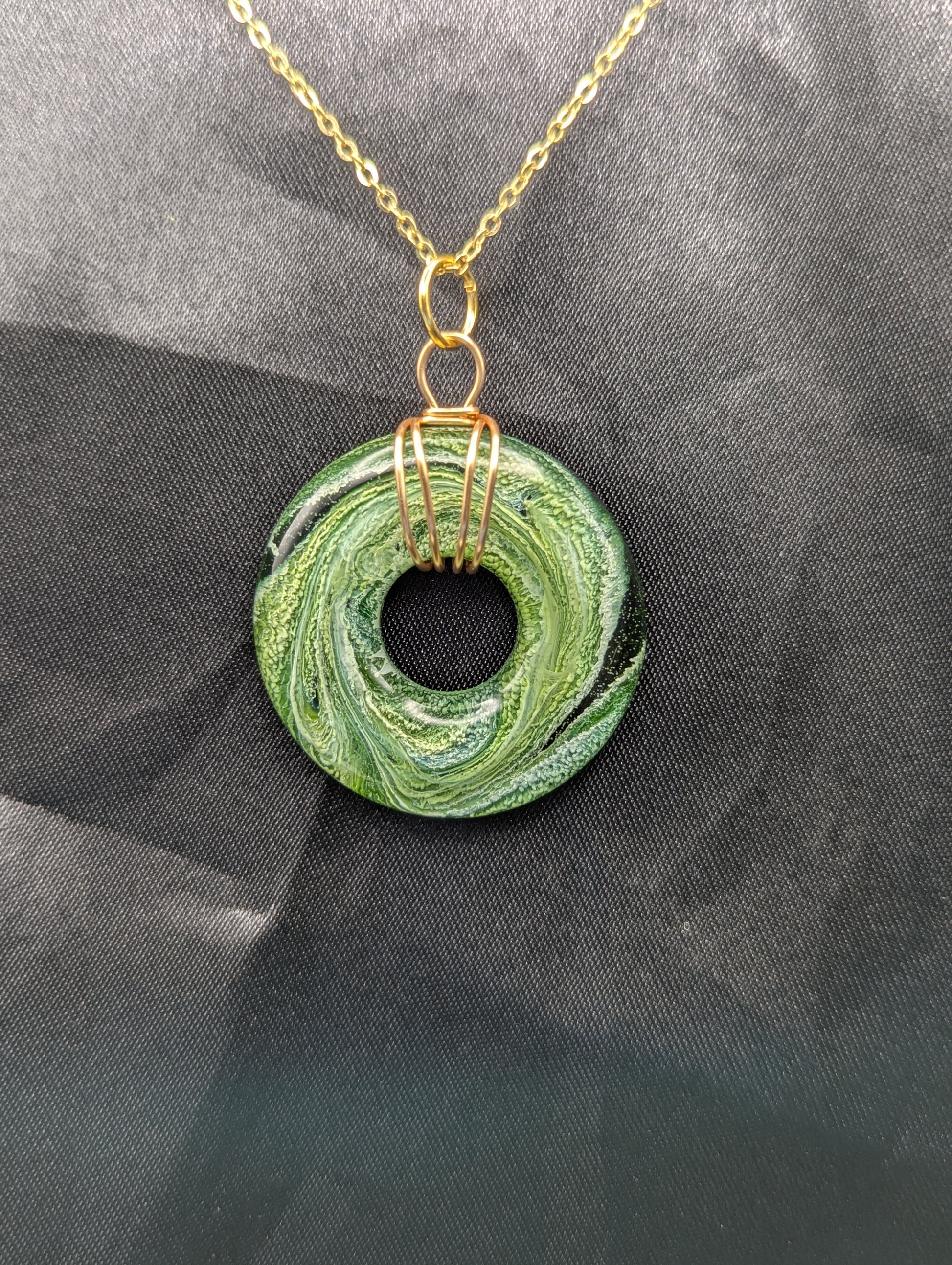 Wire Wrapped Donut Resin Pendant Necklace - Petri Effect with shades of green swirls. Resin Necklace on a gold plated metal chain.