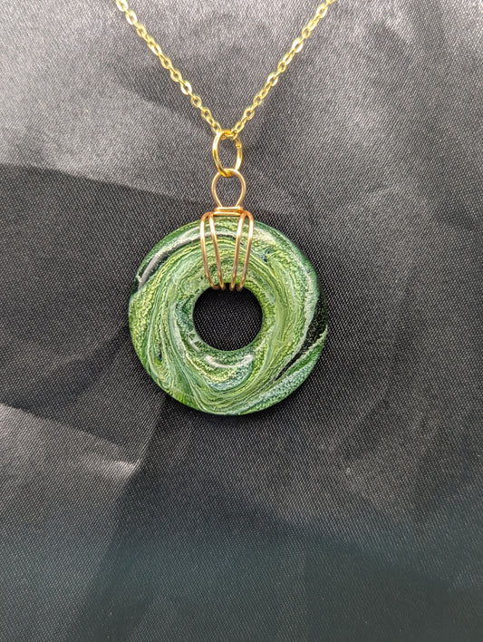 Wire Wrapped Donut Resin Pendant Necklace - Petri Effect with shades of green swirls. Resin Necklace on a gold plated metal chain.