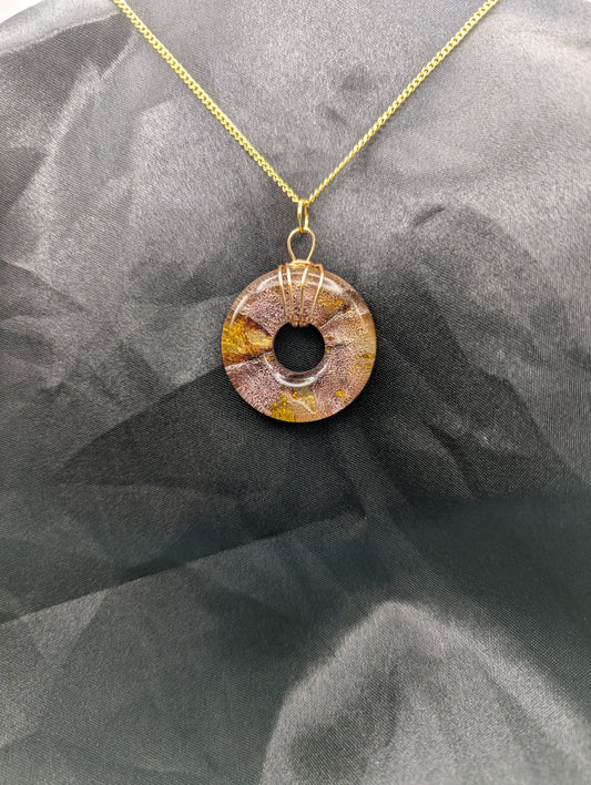 Wire Wrapped Donut Resin Pendant Necklace - Petri Effect with shades of red & gold swirls. Resin Necklace on a gold plated metal chain.