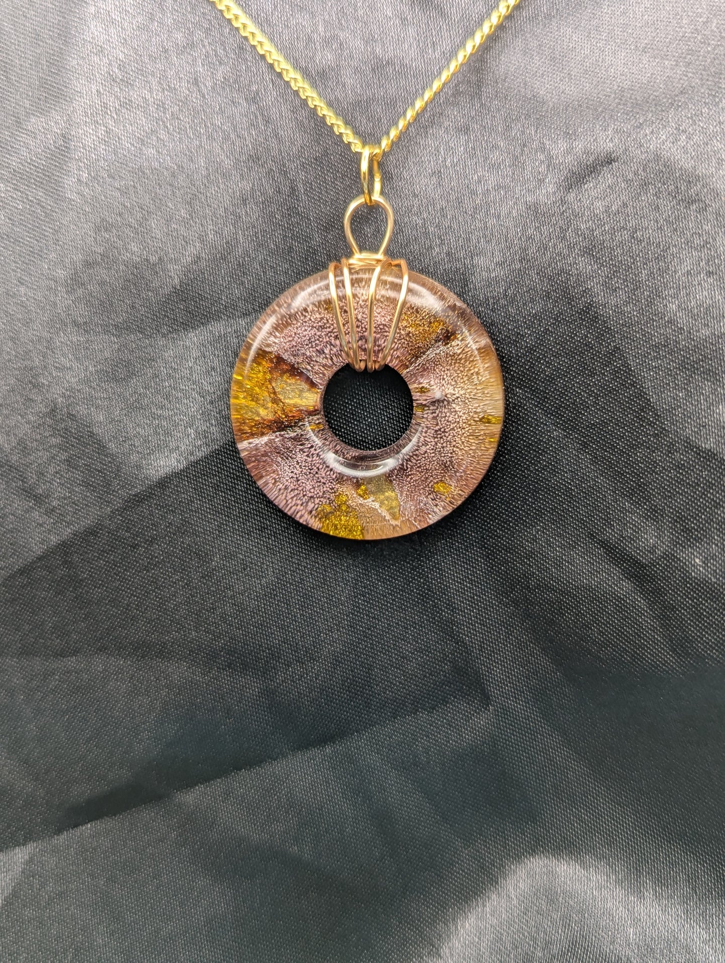 Wire Wrapped Donut Resin Pendant Necklace - Petri Effect with shades of red & gold swirls. Resin Necklace on a gold plated metal chain.
