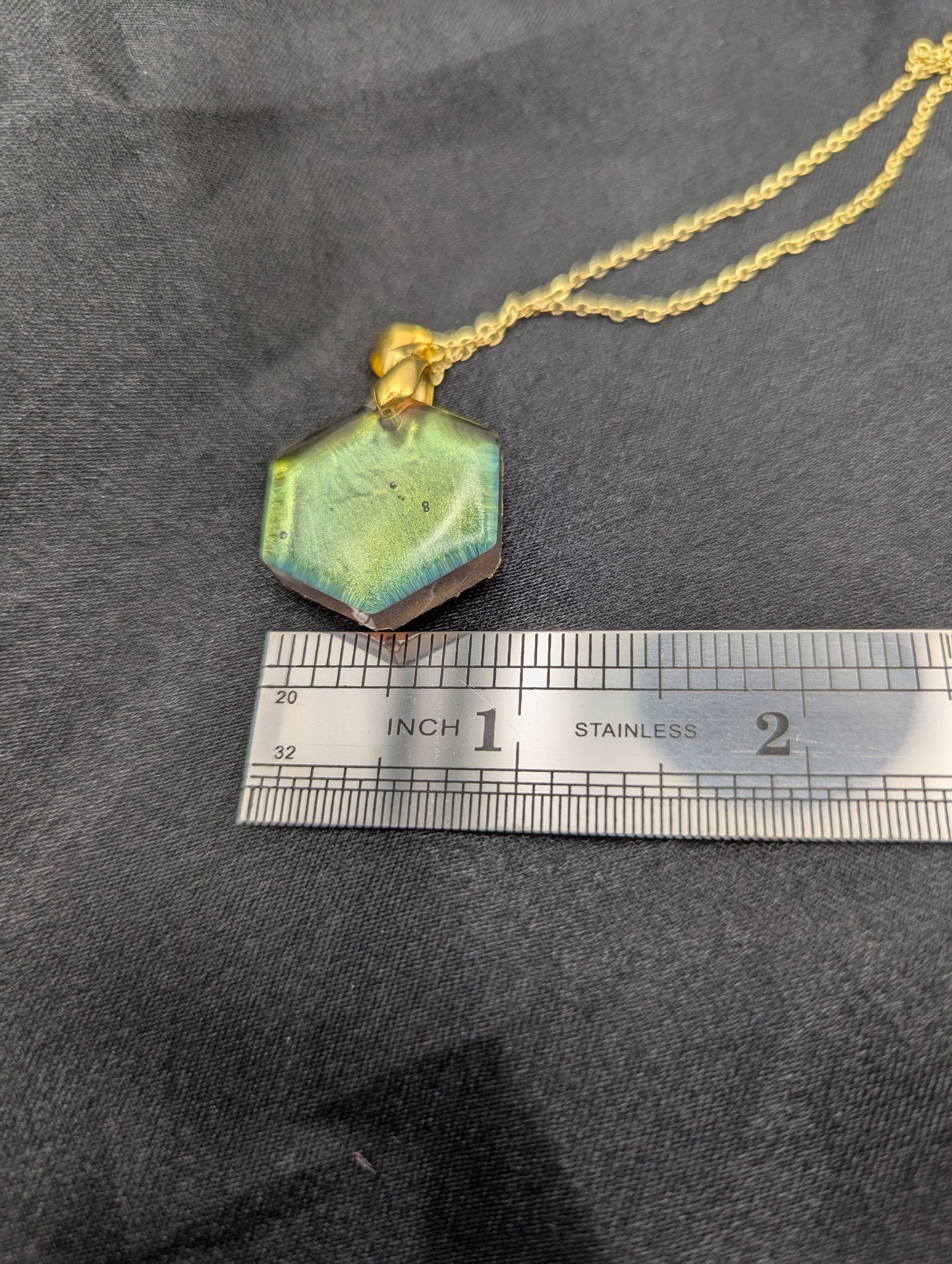 Size example pic of pendant size in inches, showing pendant is about 1 inch wide