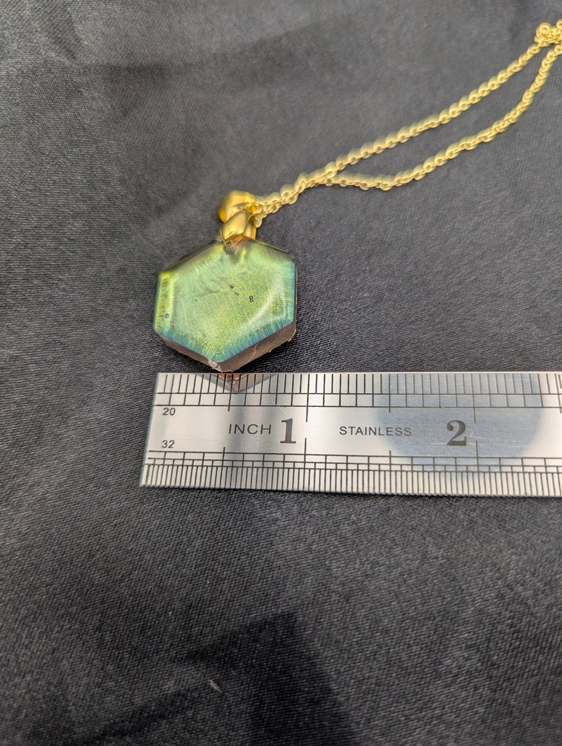 Size example pic of pendant size in inches, showing pendant is about 1 inch wide
