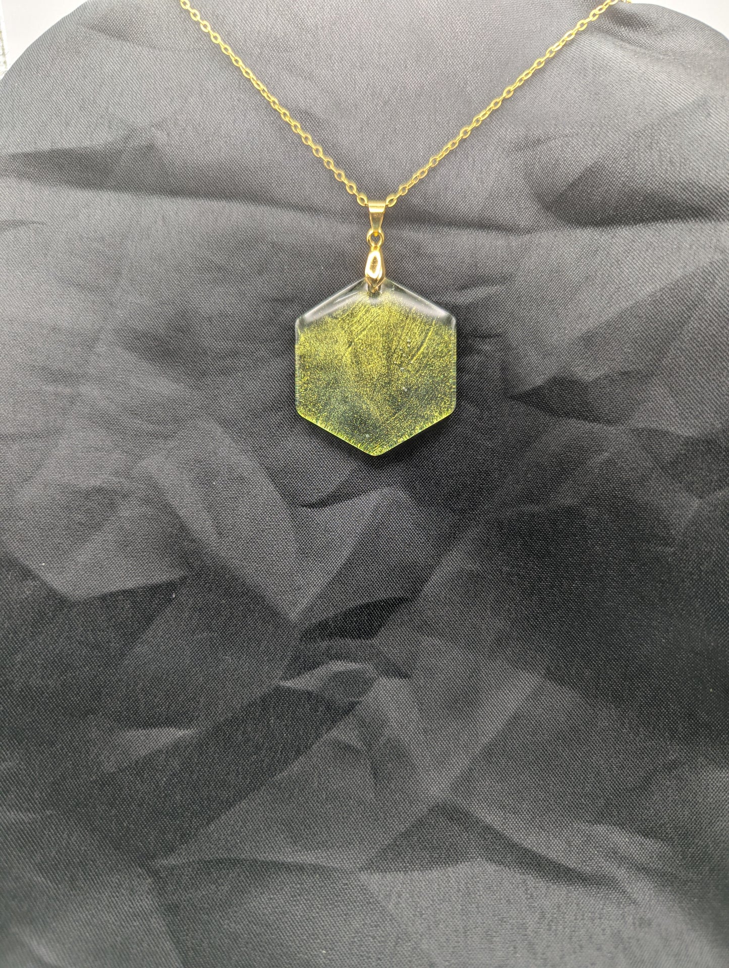 Color Shifting Hexagon Resin Pendant Necklace on a gold plated metal chain.