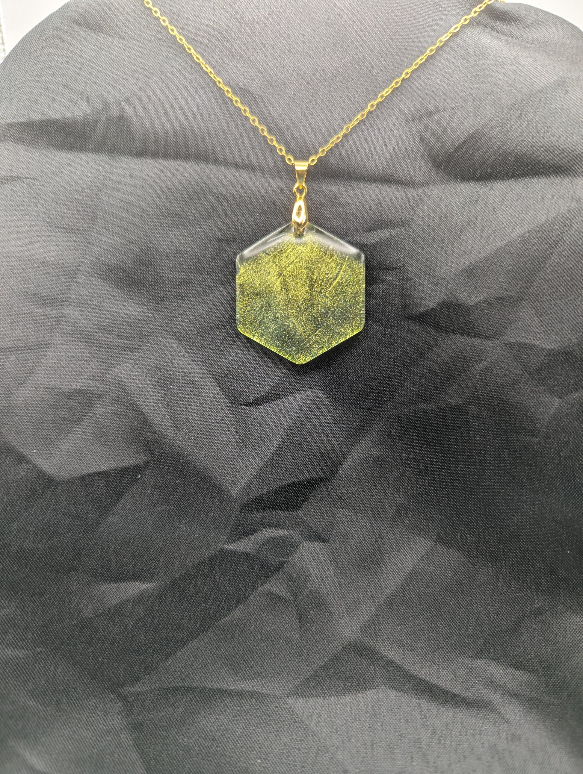 Color Shifting Hexagon Resin Pendant Necklace on a gold plated metal chain.
