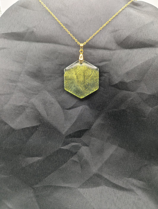 Color Shifting Hexagon Resin Pendant Necklace on a gold plated metal chain.