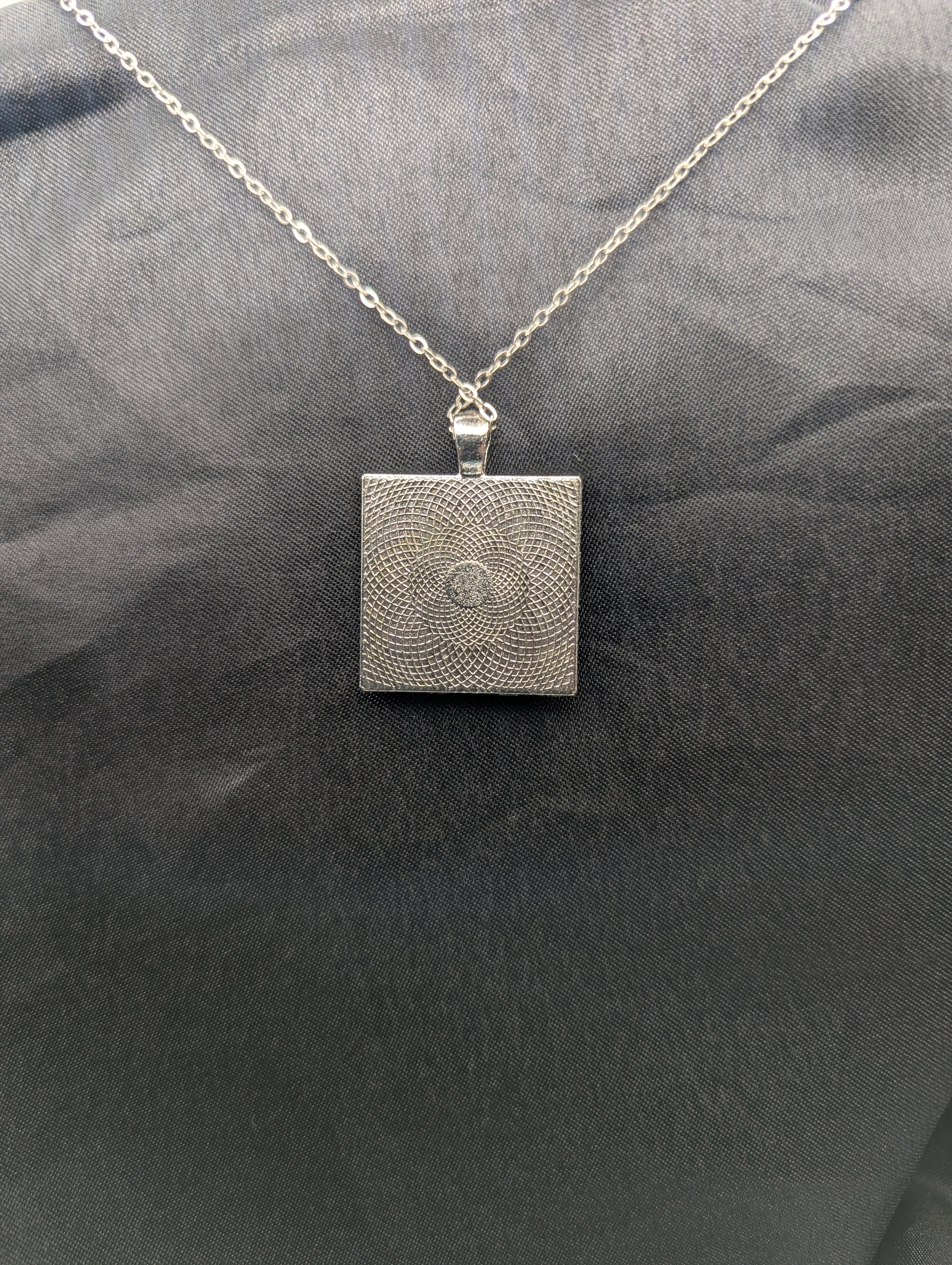 Back view of silver square bezel pendant necklace on a stainless steel chain.