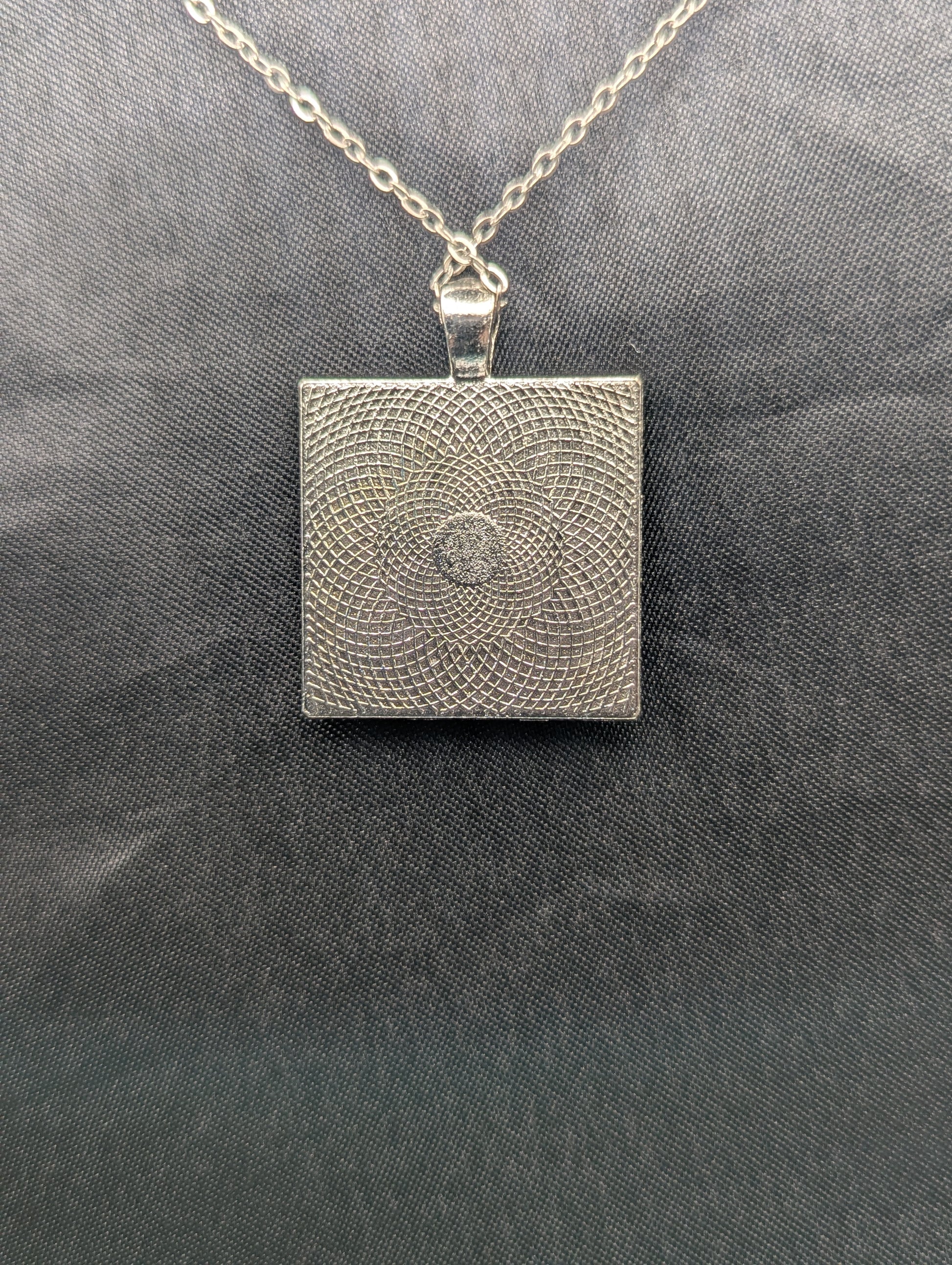 Back view of silver square bezel pendant necklace on a stainless steel chain.
