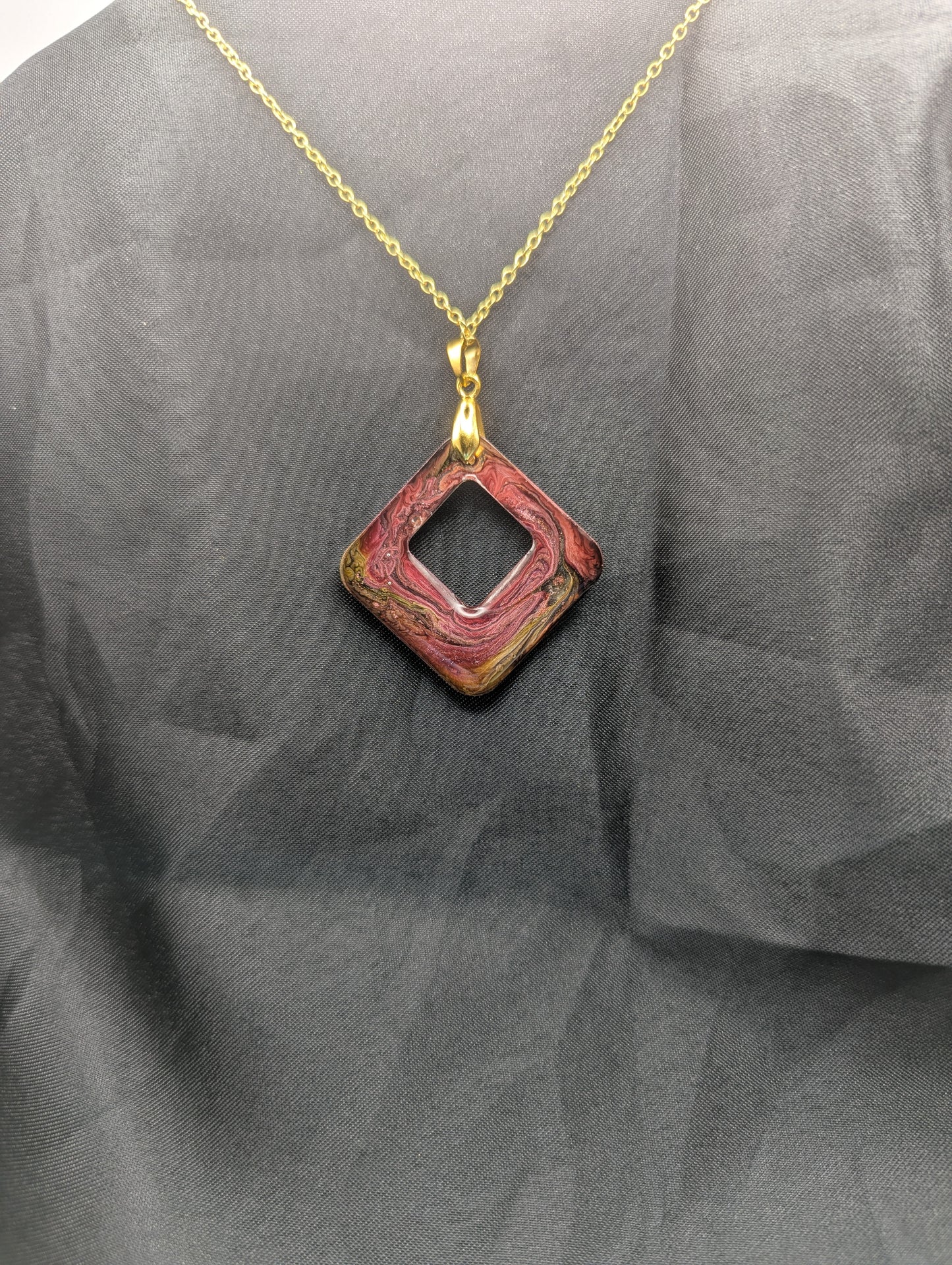 Back view of Pink & brown swirl square pendant necklace on a gold plated metal chain