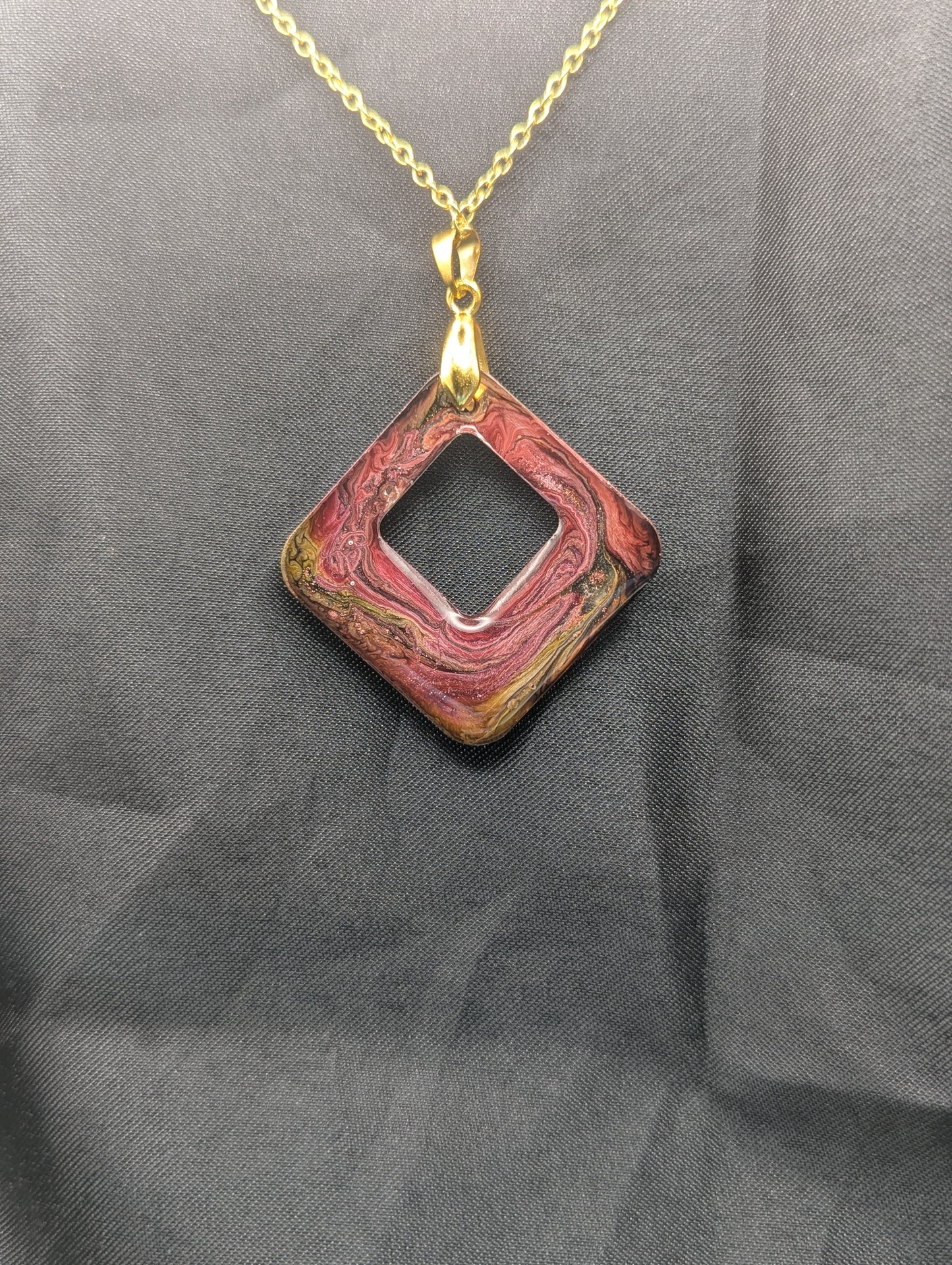 Back view of Pink & brown swirl square pendant necklace on a gold plated metal chain