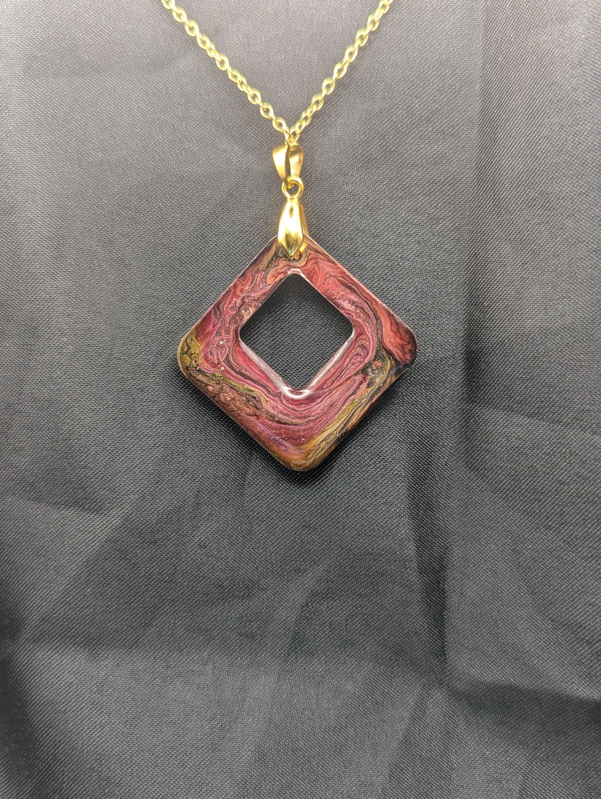 Back view of Pink & brown swirl square pendant necklace on a gold plated metal chain