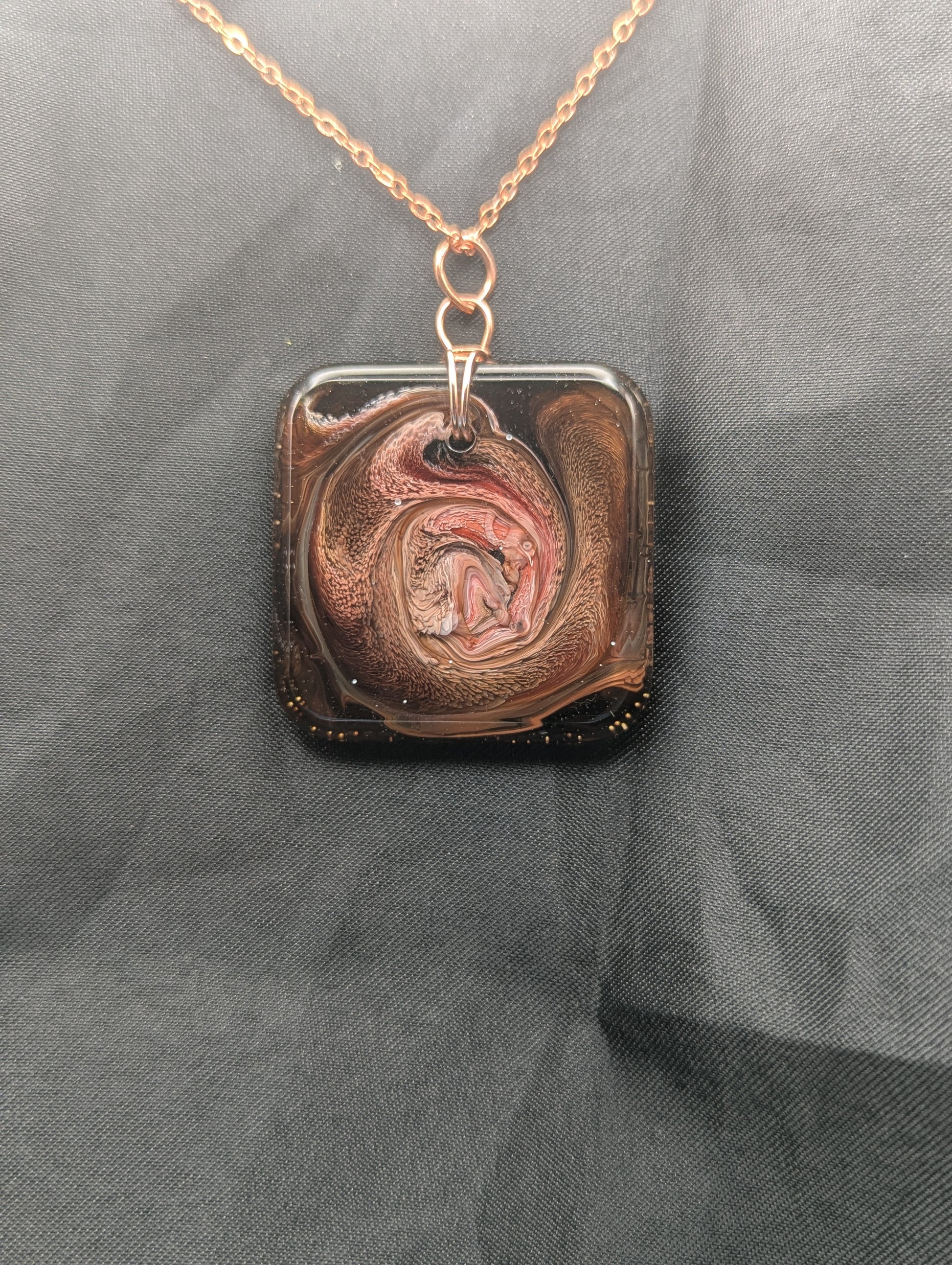 Red & Brown Swirl Square Pendant wrapped in a solid copper wire on a rose gold colored stainless steel plated metal chain. Resin Square Jewelry Pendant with Petri Effect.