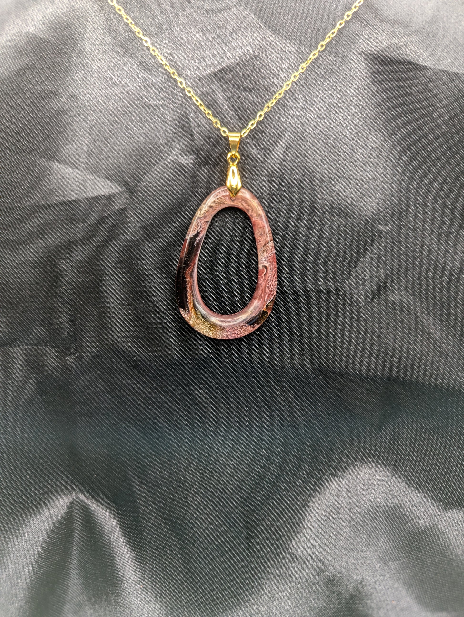 Pink & Orange Zero Shaped Resin Pendant Necklace - Petri Effect with shades of pink, orange, & red swirls. Resin Necklace on a gold pinch bail & gold plated metal chain.