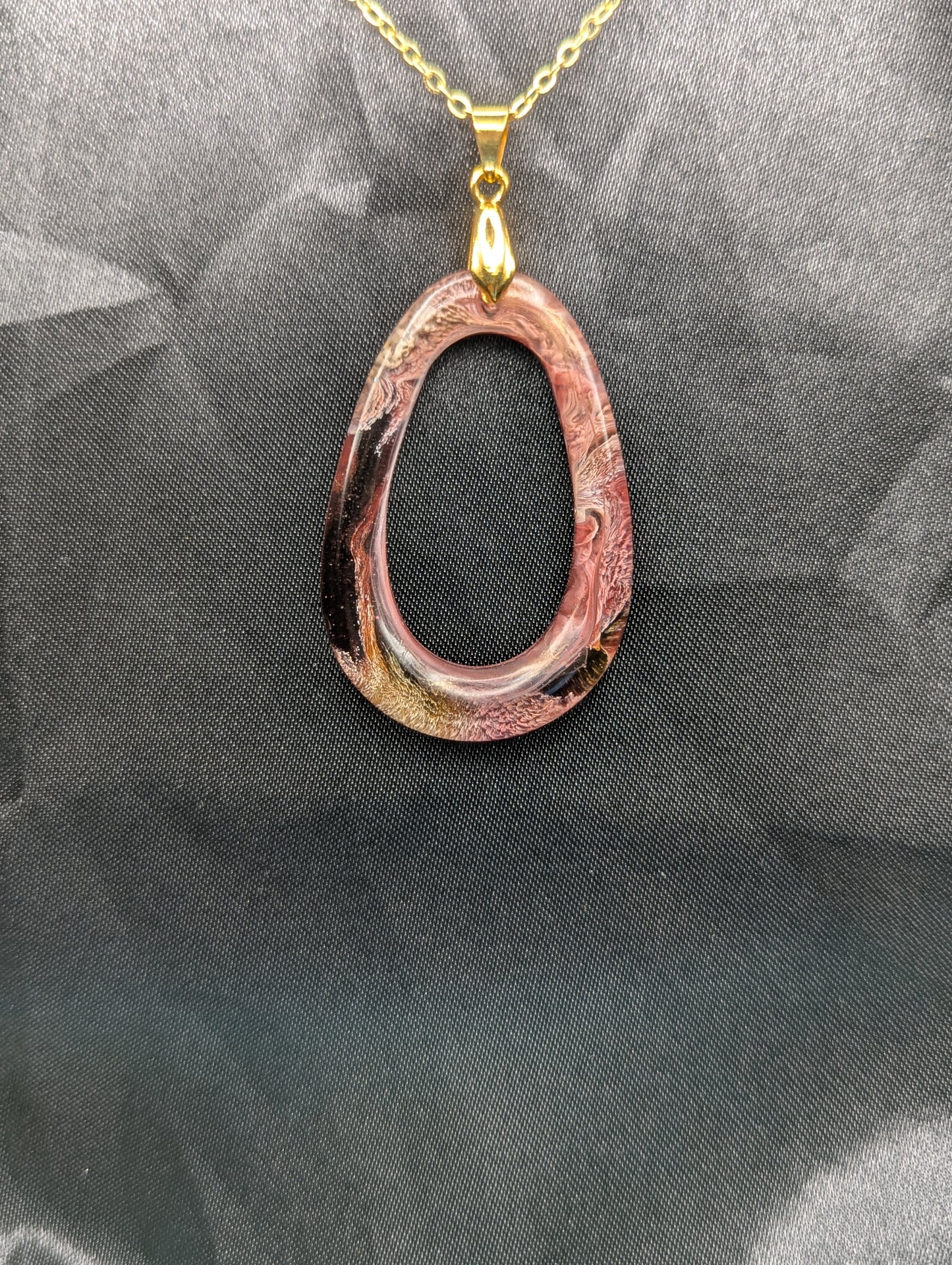 Pink & Orange Zero Shaped Resin Pendant Necklace - Petri Effect with shades of pink, orange, & red swirls. Resin Necklace on a gold pinch bail & gold plated metal chain.