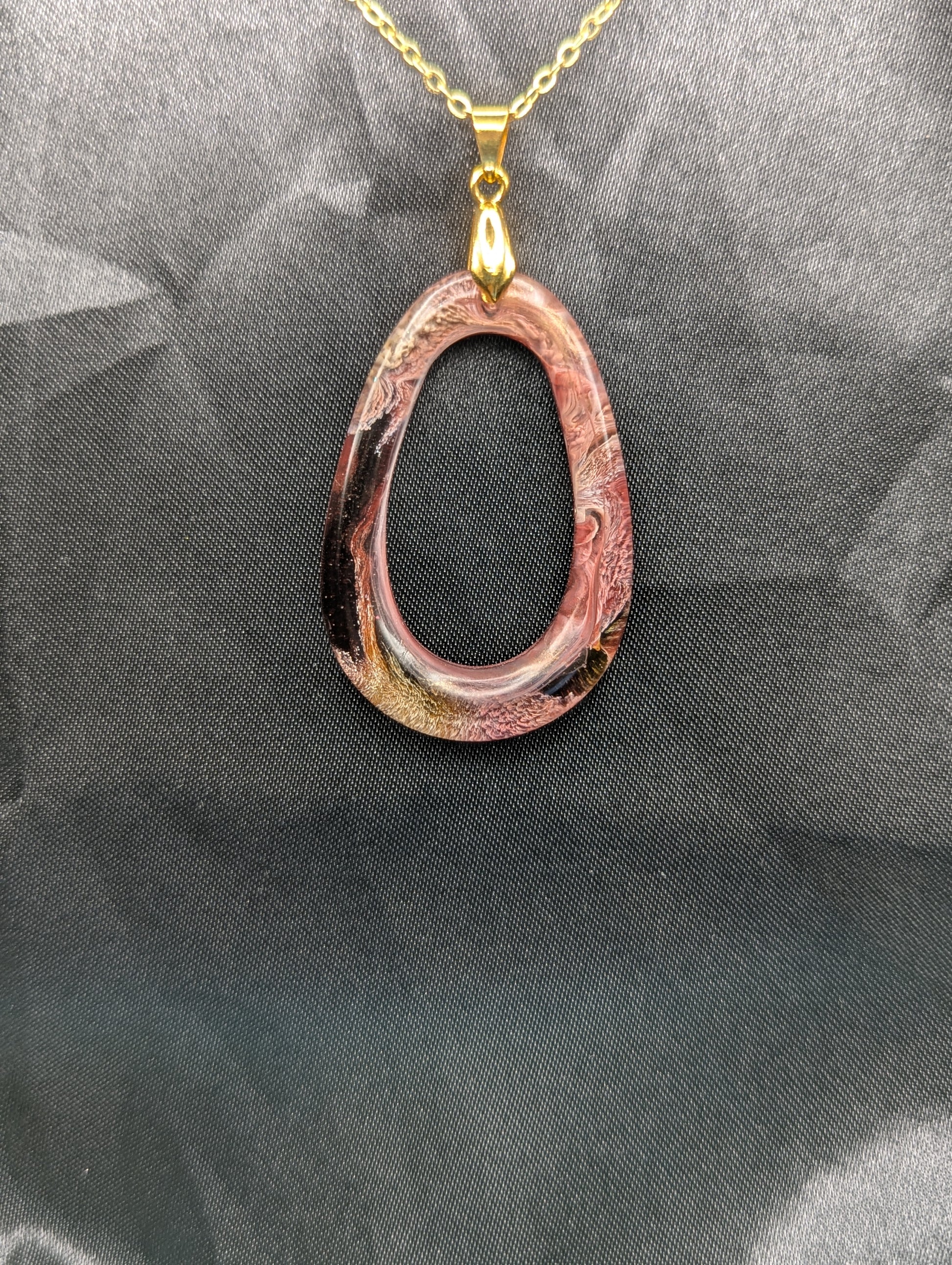 Pink & Orange Zero Shaped Resin Pendant Necklace - Petri Effect with shades of pink, orange, & red swirls. Resin Necklace on a gold pinch bail & gold plated metal chain.