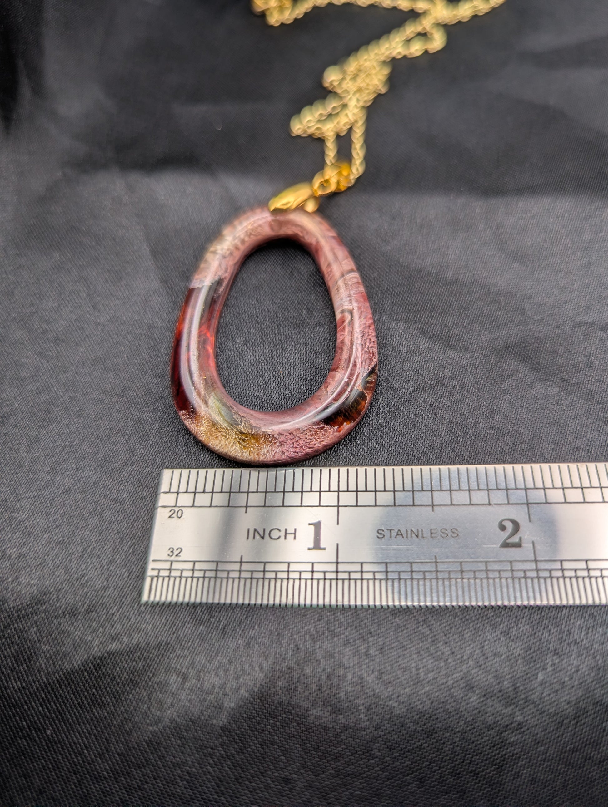 Size example pic of pendant size in inches, showing pendant is about 1.25 inches wide.