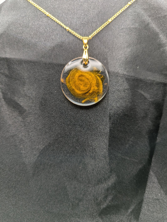 Yellow & Orange Swirl Circle Resin Pendant with a gold pinch bail on a gold plated metal chain.