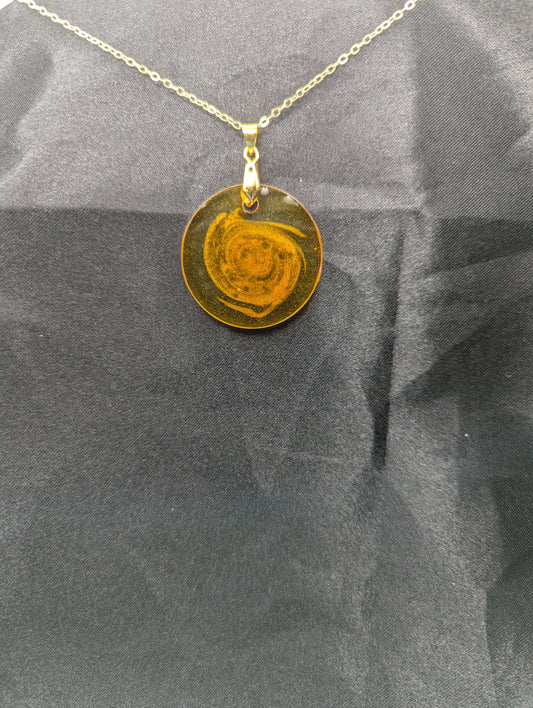 Yellow & Orange Swirl Resin Circle pendant on a gold pinch bail & gold plated metal chain
