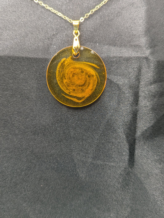 Yellow & Orange Swirl Resin Circle pendant on a gold pinch bail & gold plated metal chain