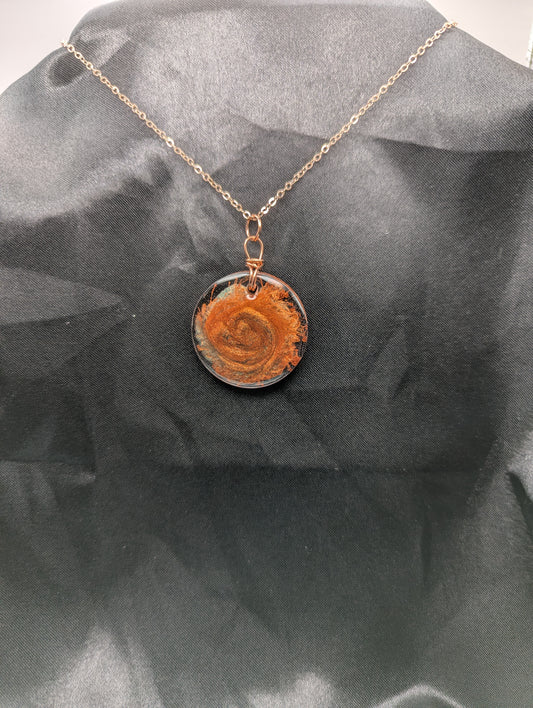 Copper Swirl Circle Resin Pendant wrapped in a pure copper wire on a rose colored stainless steel plated metal chain.