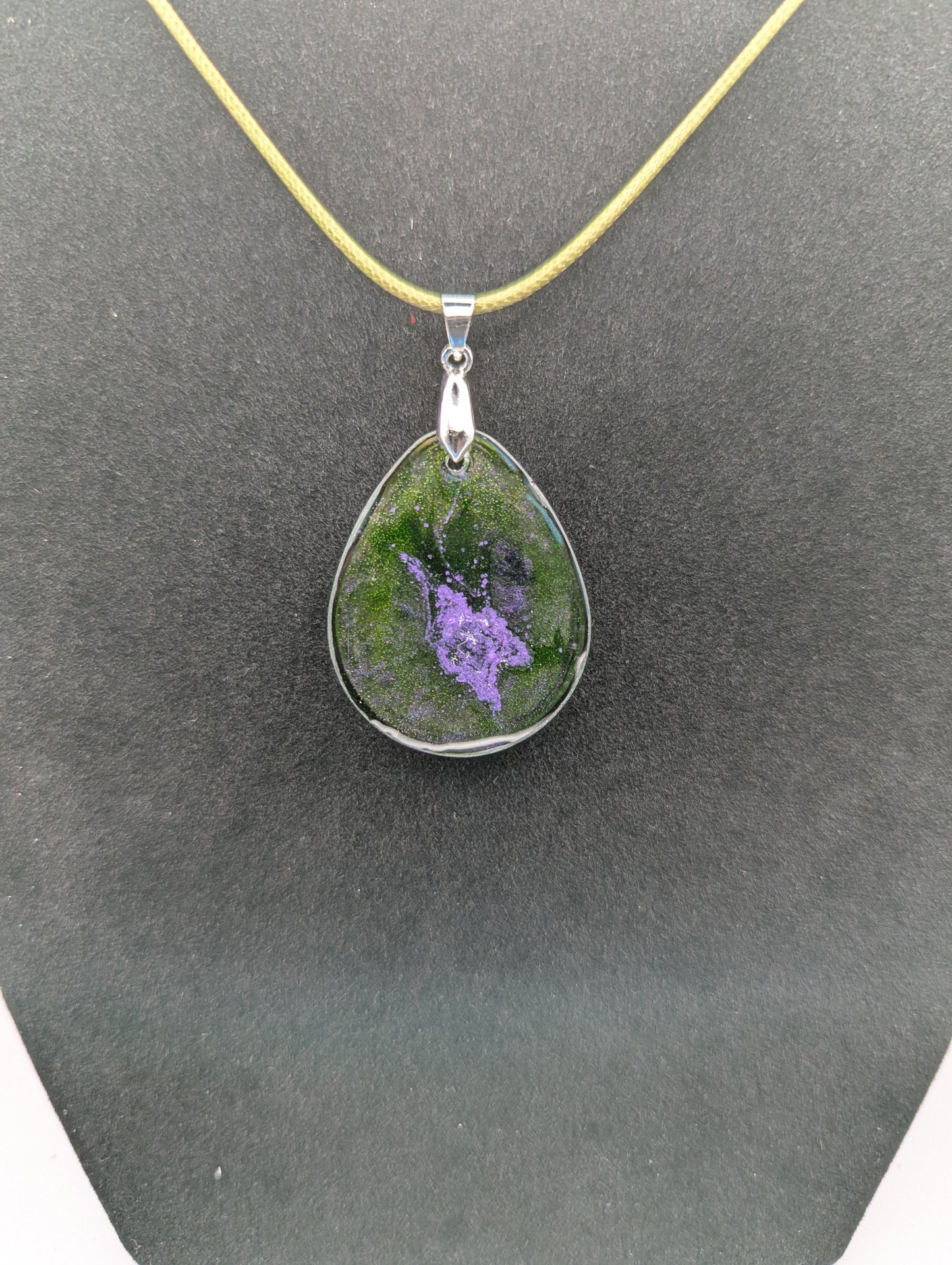 Back view of Teardrop Resin Pendant Necklace - Green & sparkly in color with pops of purple. Resin necklace on a waxed cotton cord.