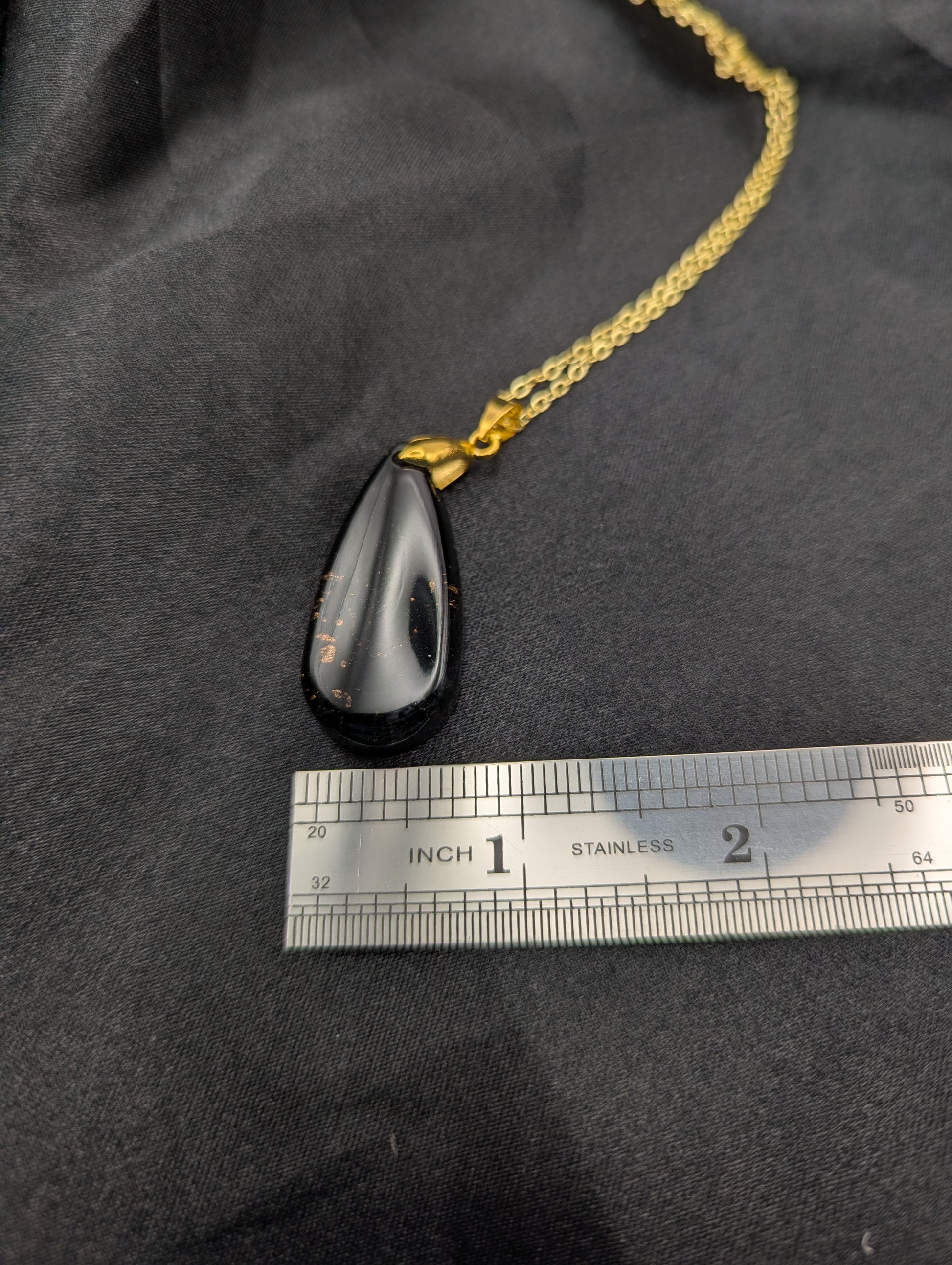 Size example pic of pendant size in inches, showing pendant is about 0.75 inches wide at base